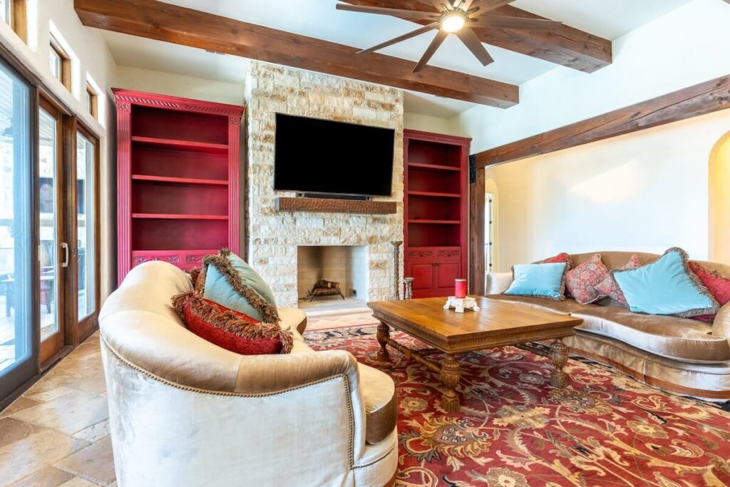 A cozy, rustic living room with wood beams along the ceiling, a classic log cabin decor idea