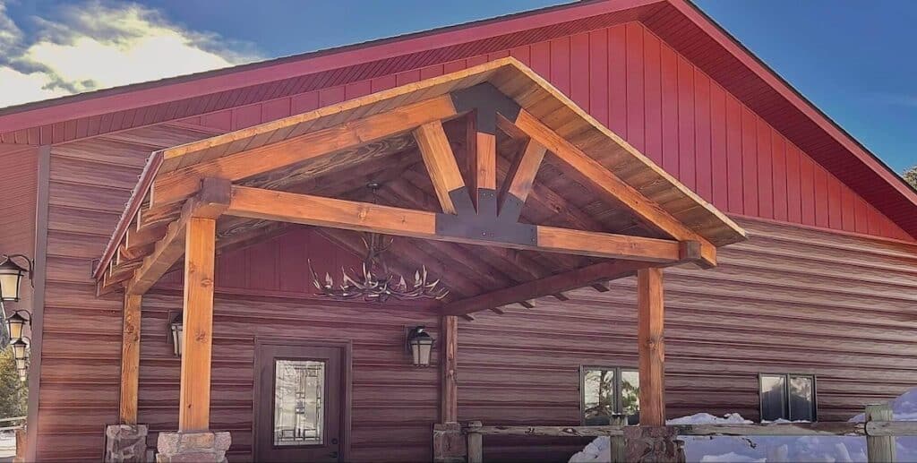 A home that embraces log cabin decor with an antler light fixture and TruLog steel log siding