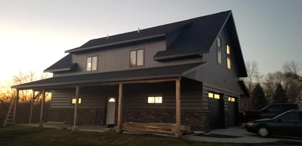 Barndonminium at sunset with a combo of TruLog steel board and batten siding and log siding