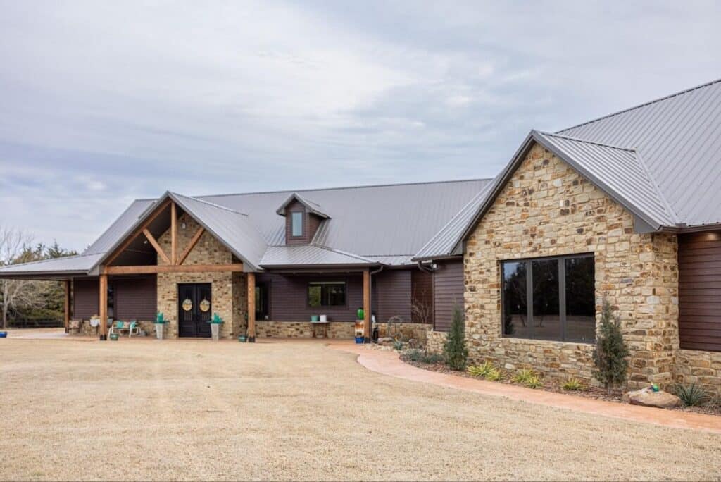 A beautiful home with a mix of stone and TruLog steel lap siding, which is a great option for those weighing dutch lap vs. clapboard
