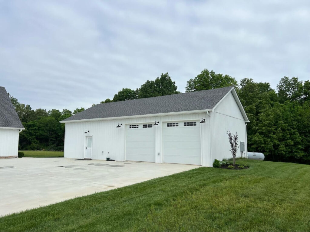 A detached extra-large two-car garage with TruLog steel board and batten siding in Matte White