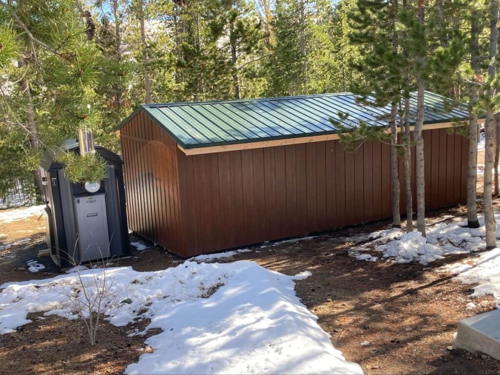 An outbuilding on residential property with TruLog steel board and batten siding