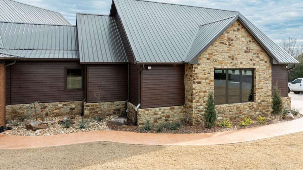 The side of a home with stone accents and TruLog steel lap siding
