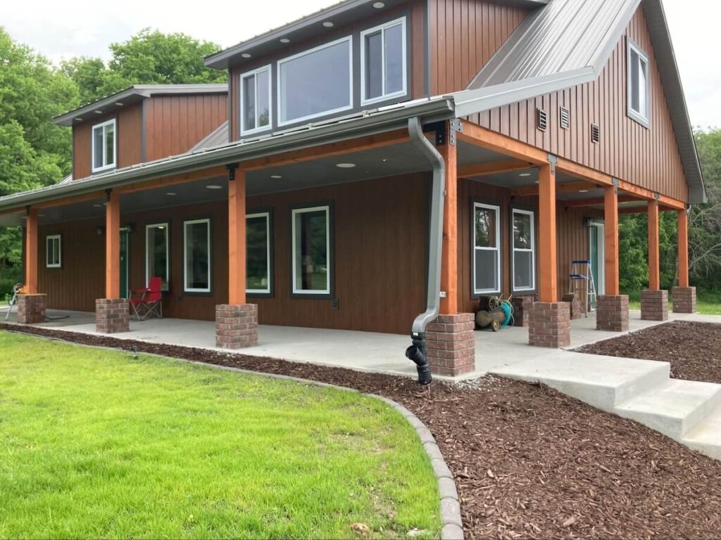 A barndominium with TruLog steel board and batten siding in Western Cedar