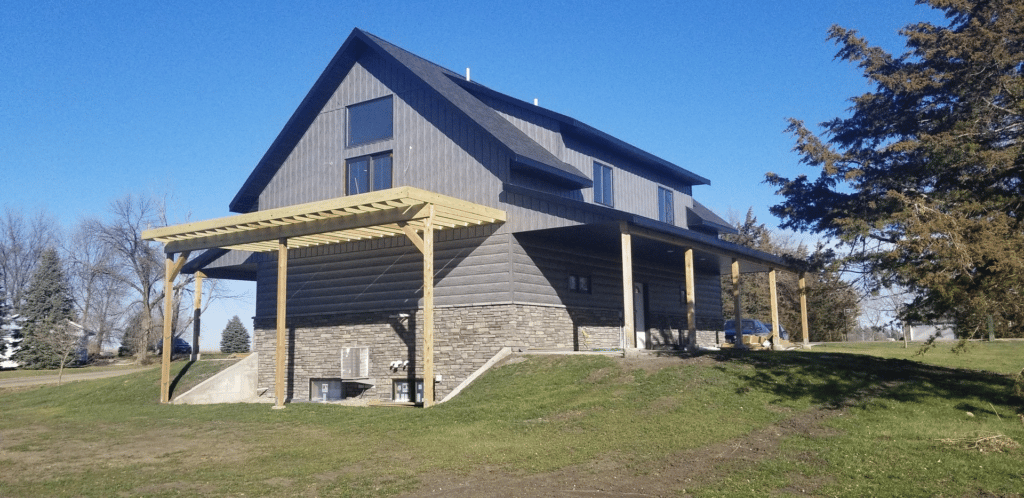 Flagstone Foundation and Layers of Lap - Gray Board and Batten Siding