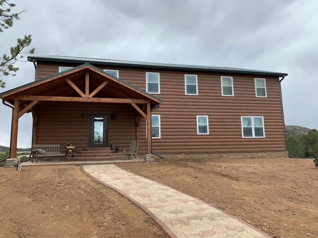 Barndominium with TruLog steel log siding in western cedar
