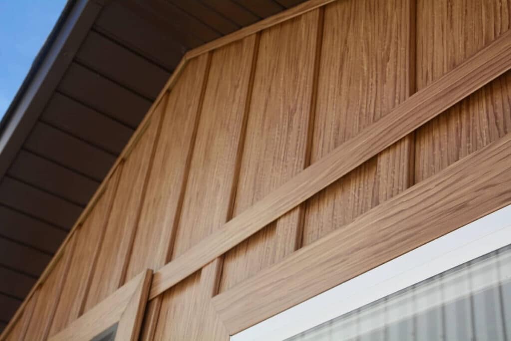 A closeup of TruLog's woodgrain steel board and batten siding