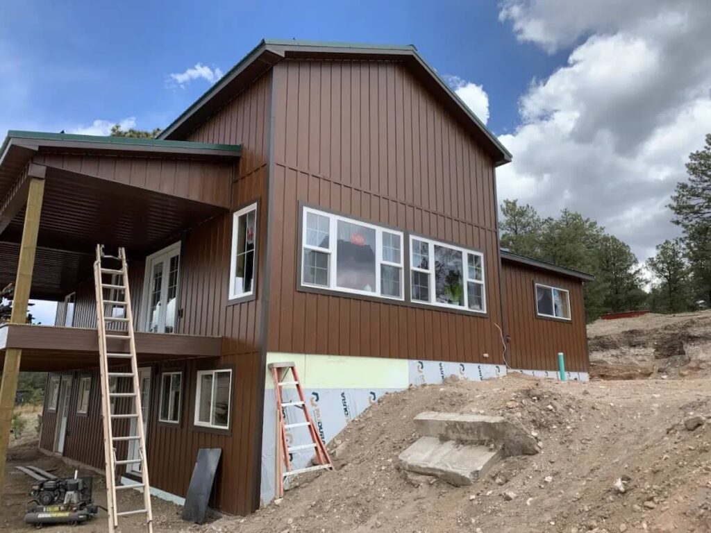 TruLog board and batten siding being installed on a home