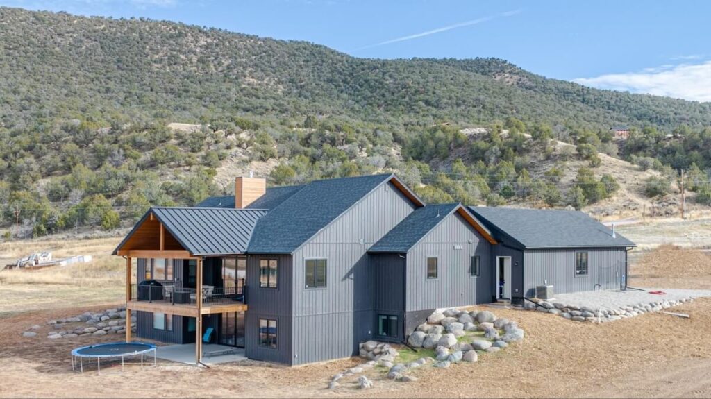 A home with TruLog steel board and batten siding in Dark Charcoal
