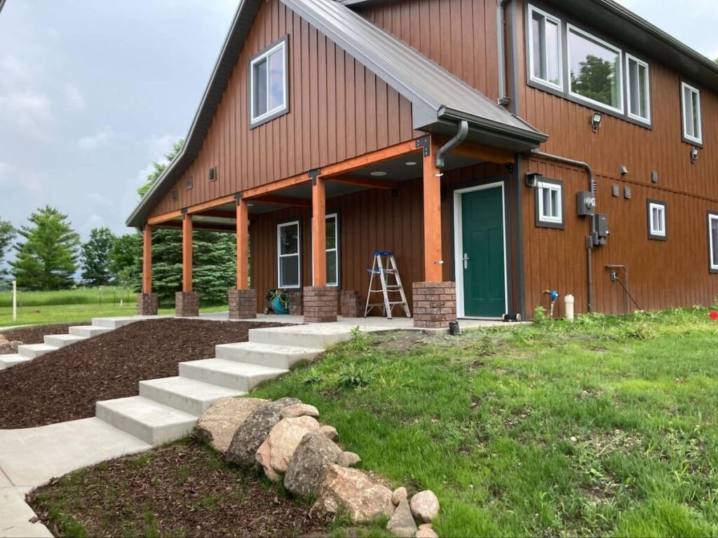 A home in TruLog steel board and batten siding in the color Western Cedar
