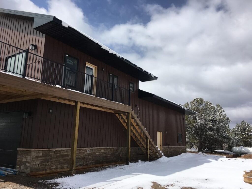 A home during the winter with TruLog steel board and batten siding