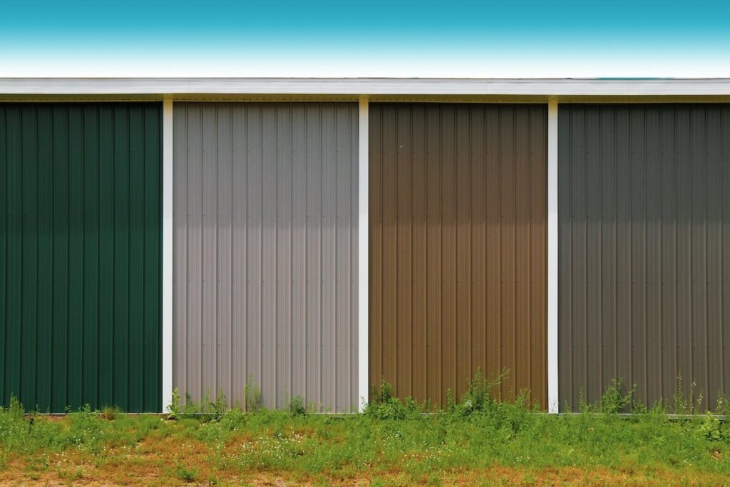 The side of a building with panels of metal siding painted in different colors