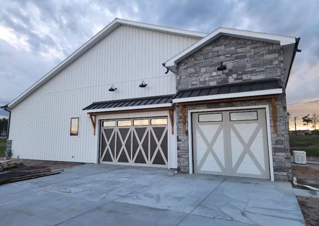 A home with an eye-catching style that combines stone with TruLog steel board and batten siding in matte white