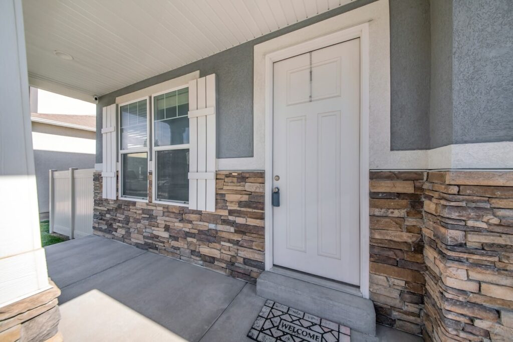 The front porch of a home with stone veneer siding
