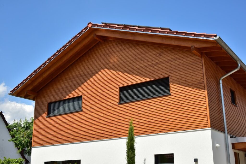 The side of a home exterior with wood Dutch lap siding