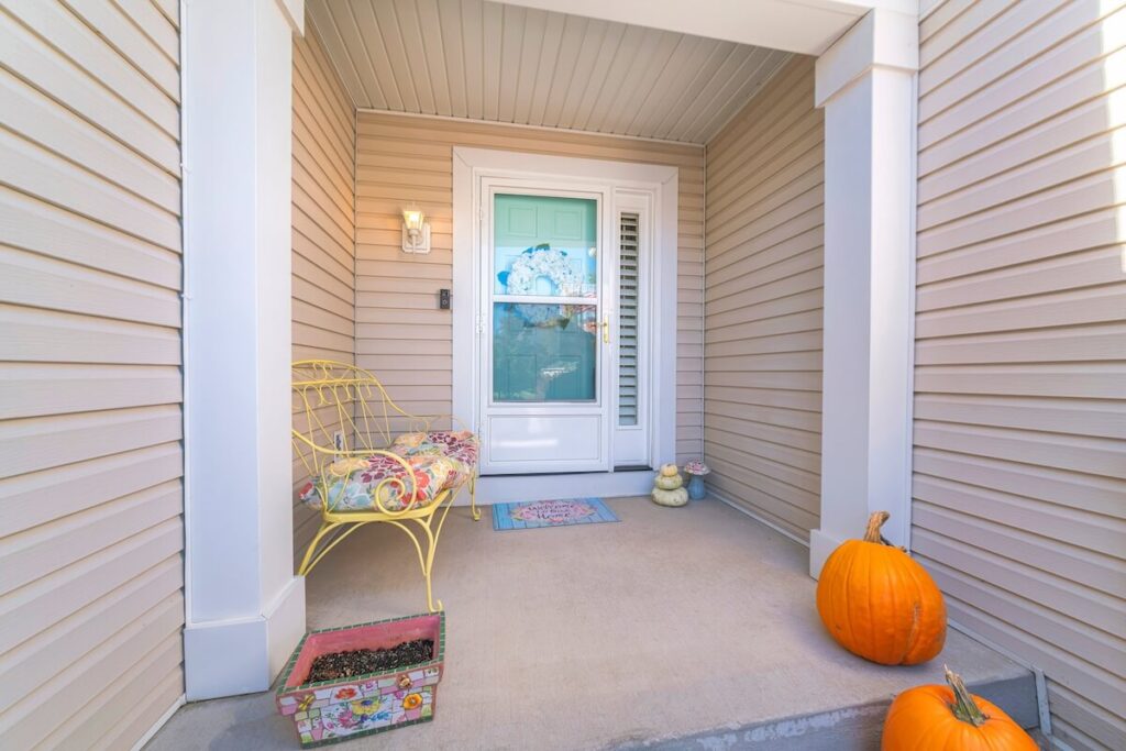 The closeup of a home's front entry with vinyl Dutch lap siding