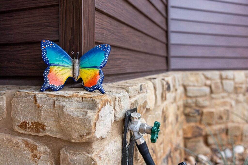 A closeup of a home with TruLog steel lap siding and stone accents
