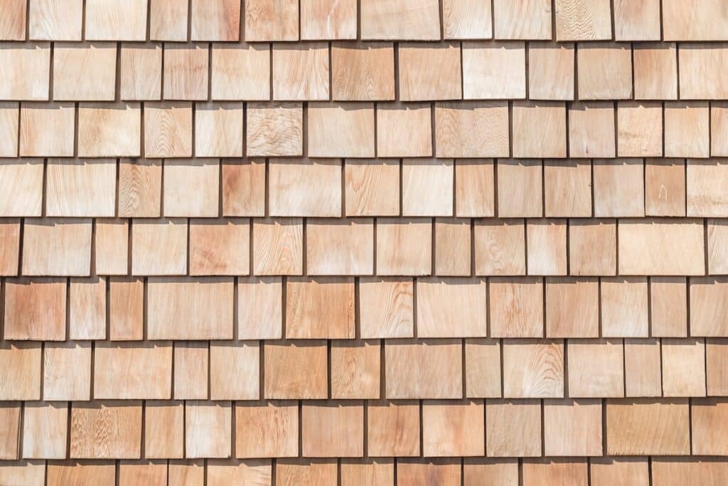 A closeup of cedar shingle siding