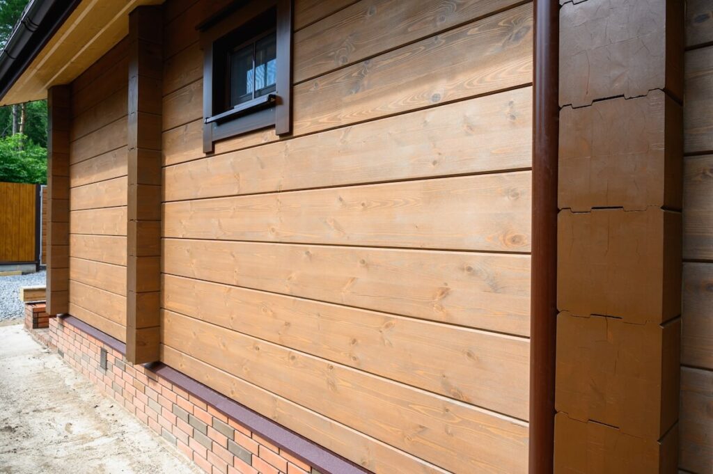 A closeup of wood siding on the exterior of a cottage