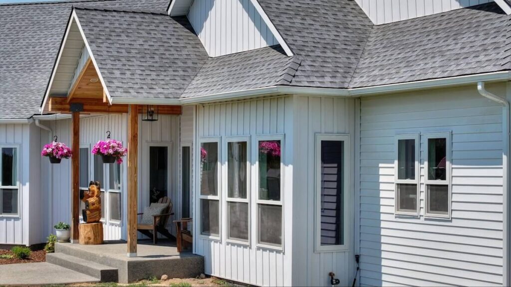 The front porch of a home featuring TruLog steel lap and board and batten siding in Matte White