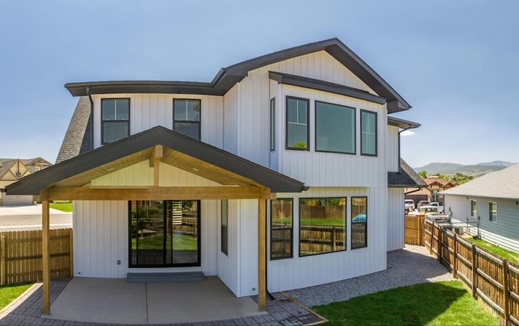 A new home with TruLog steel board and batten siding, a low-maintenance siding option