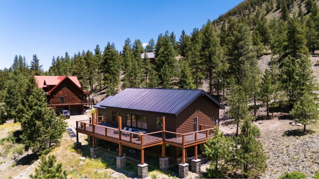 A home in the mountains surrounded by trees that's protected with TruLog steel log siding