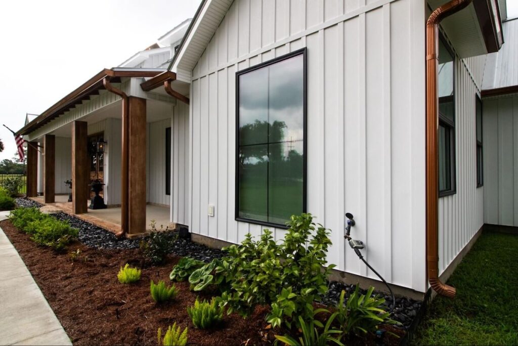 A closeup view of a ranch home with TruLog steel board and batten vertical siding