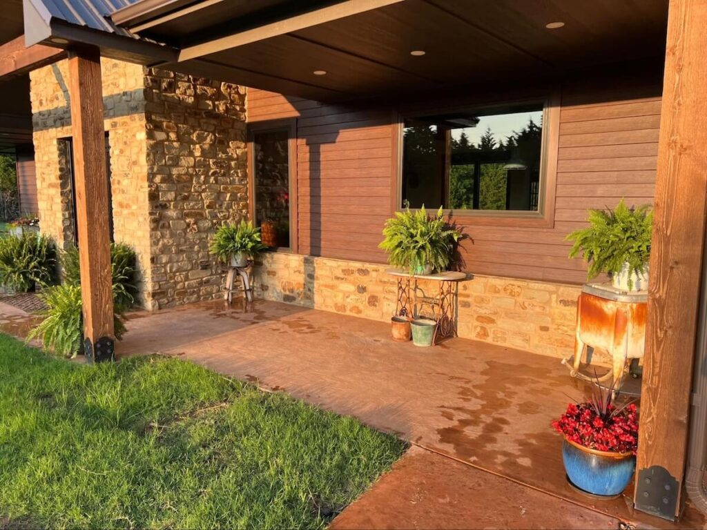 A closeup of a porch in warm sunlight on a home with TruLog steel lap siding with a real wood look