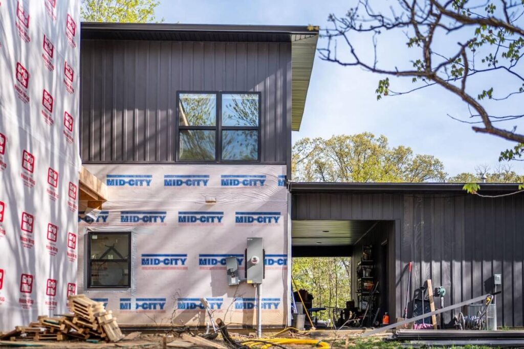 A home being re-sided with TruLog steel board and batten siding