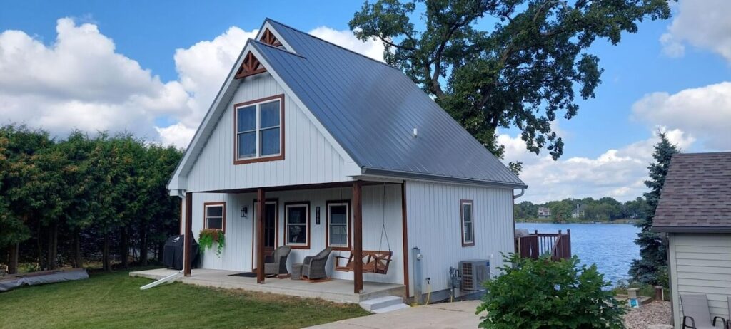 A lakeside cottage with TruLog steel board and batten siding in Matte White