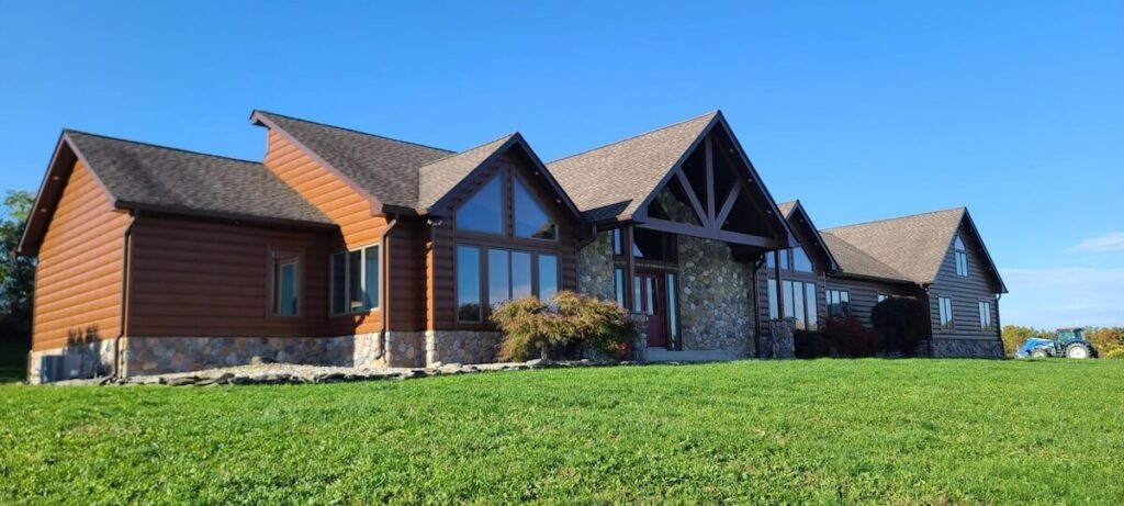 A modern cabin exterior with a combination of stone and TruLog steel log siding
