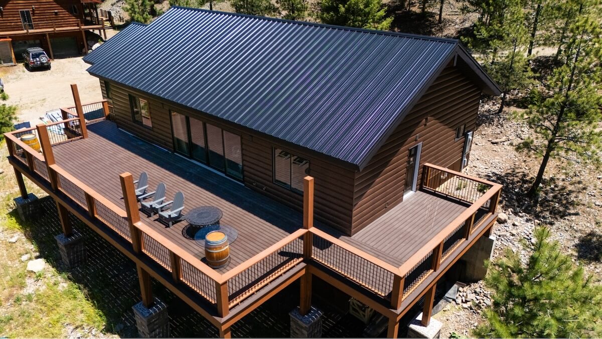 How long does siding last? Aerial view of a home with a big porch and TruLog steel log siding