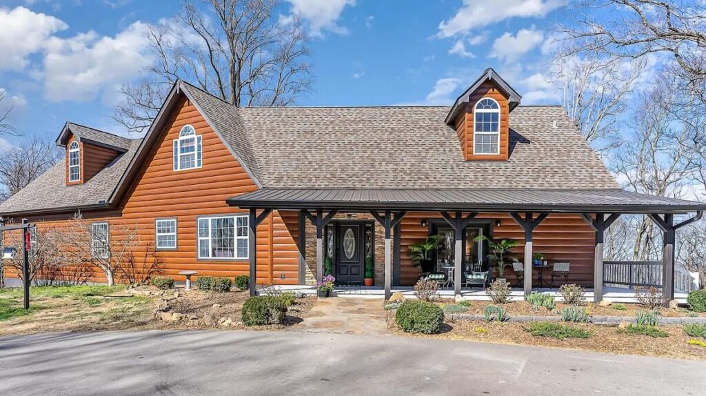 A beautiful home with TruLog steel log siding on a sunny day in early spring
