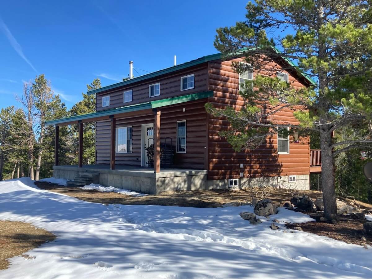 A home with insulated TruLog steel log siding in the wintertime