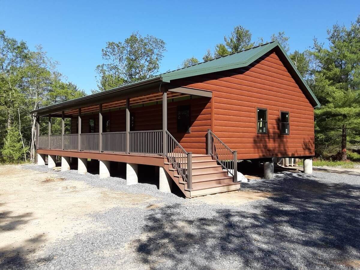Home with brown wood-look TruLog steel siding and a covered porch.
