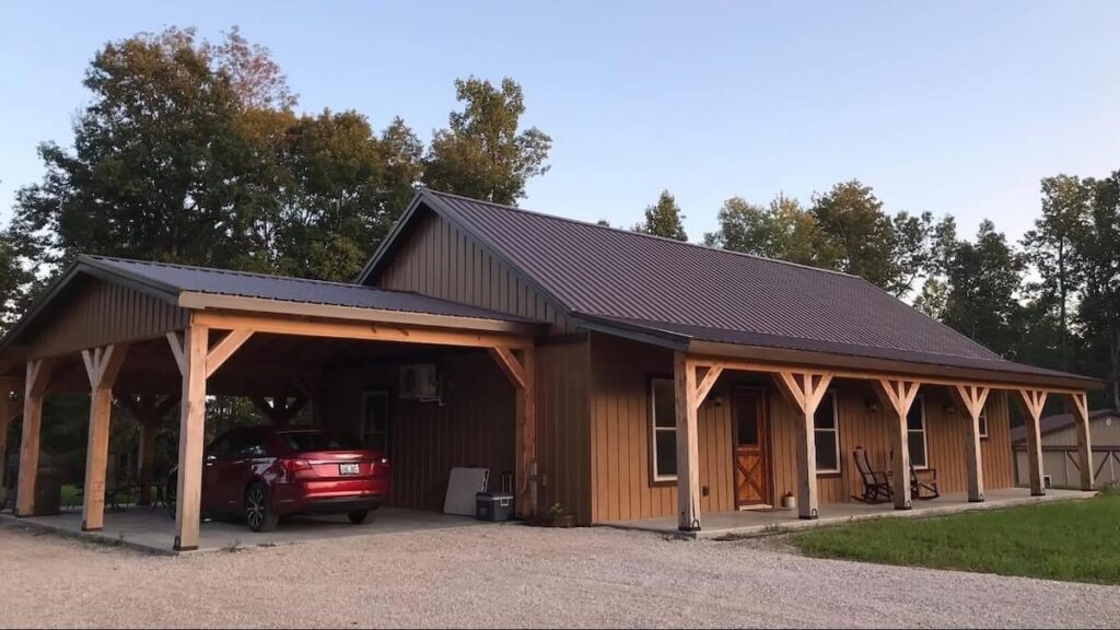 A modern rustic pole barn style home with TruLog steel board and batten siding in Cedar