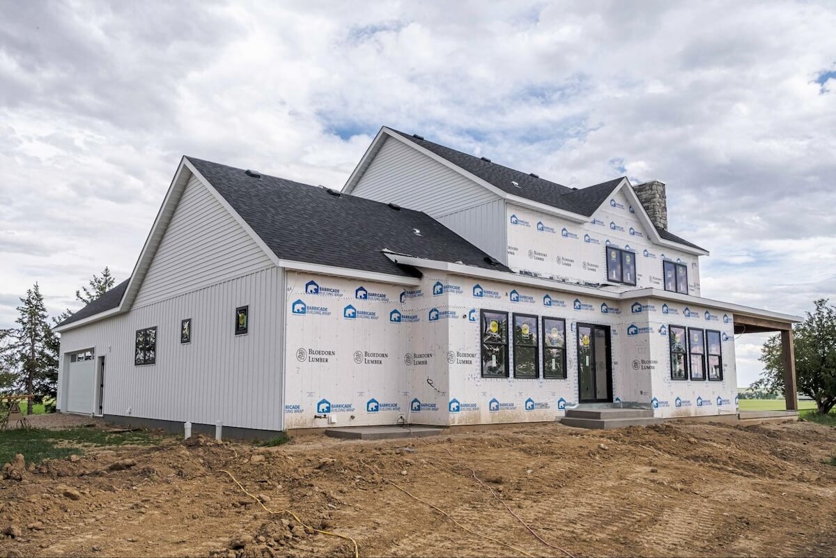 A new build in house wrap having TruLog steel siding installed in Matte White