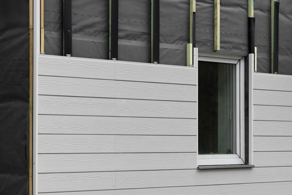 A closeup of a home having cladding installed
