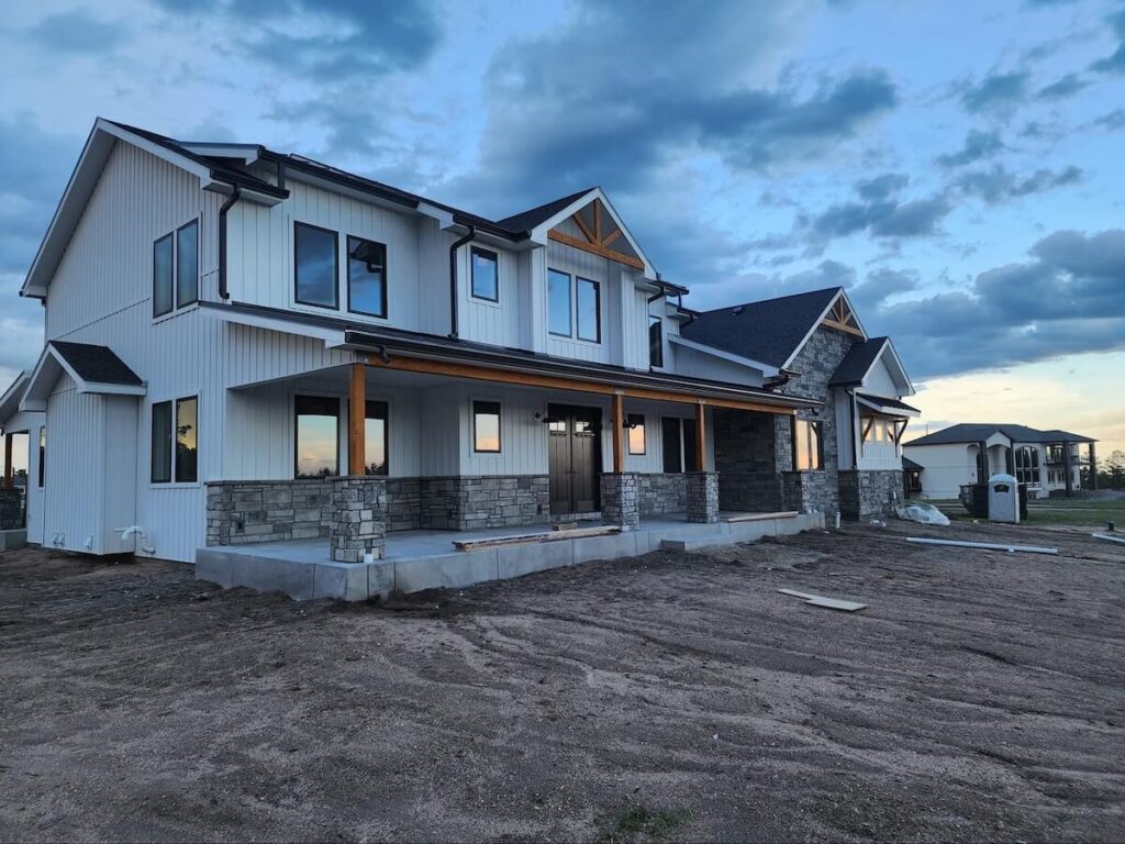 A newly built modern farmhouse with TruLog steel board and batten siding in Matte White
