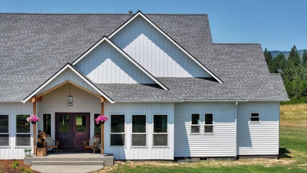 A beautiful home with a mix of TruLog steel lap siding as well as board and batten siding in Matte White
