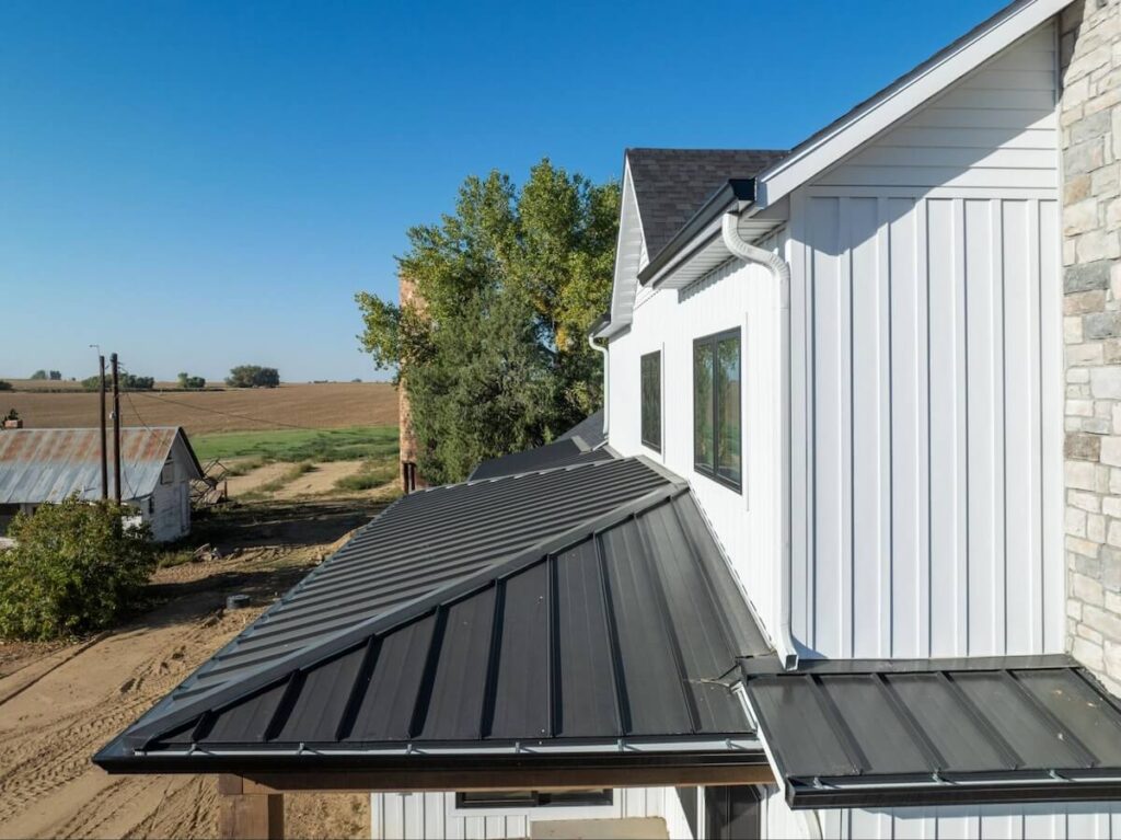 A closeup of the second-floor exterior of a home with TruLog steel board and batten siding in Matte White