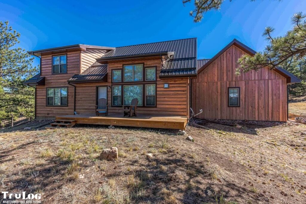 TruLog TruGrain steel siding on a lakeside cabin in Minnesota against a blue sky.